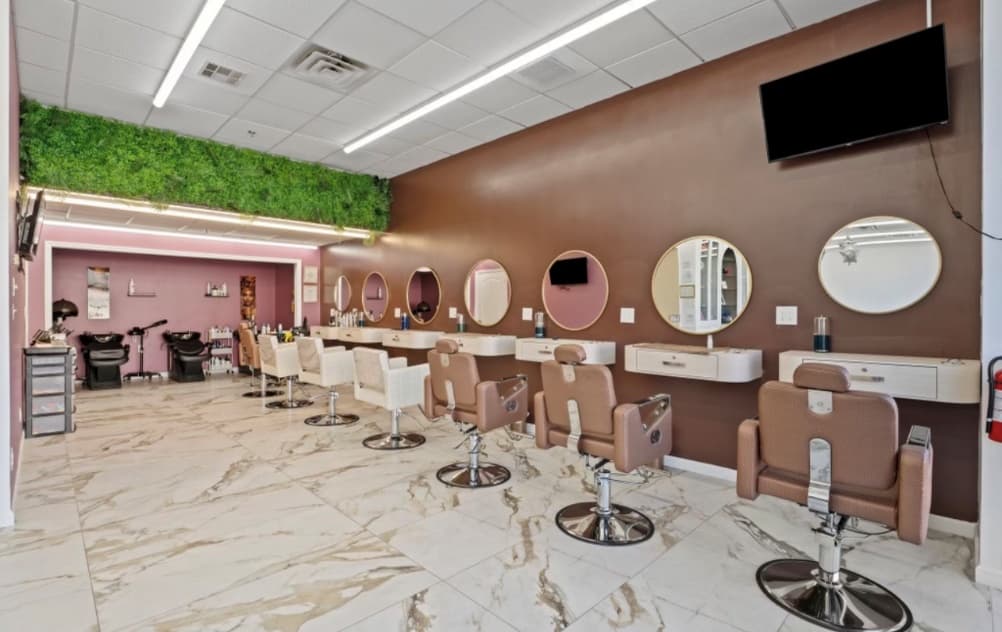 ReVibe styling floor with round gold mirrors, salon chairs and a green living wall